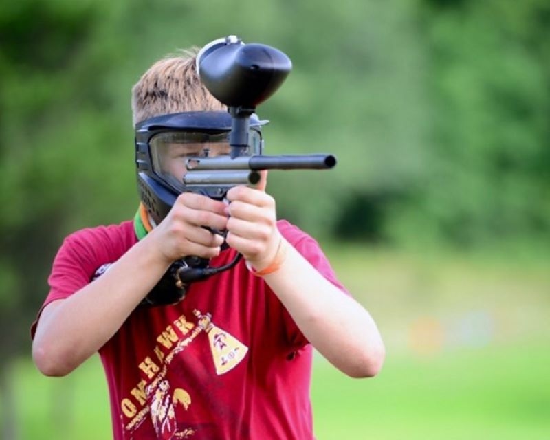 A scout geared for the paintball range takes aim